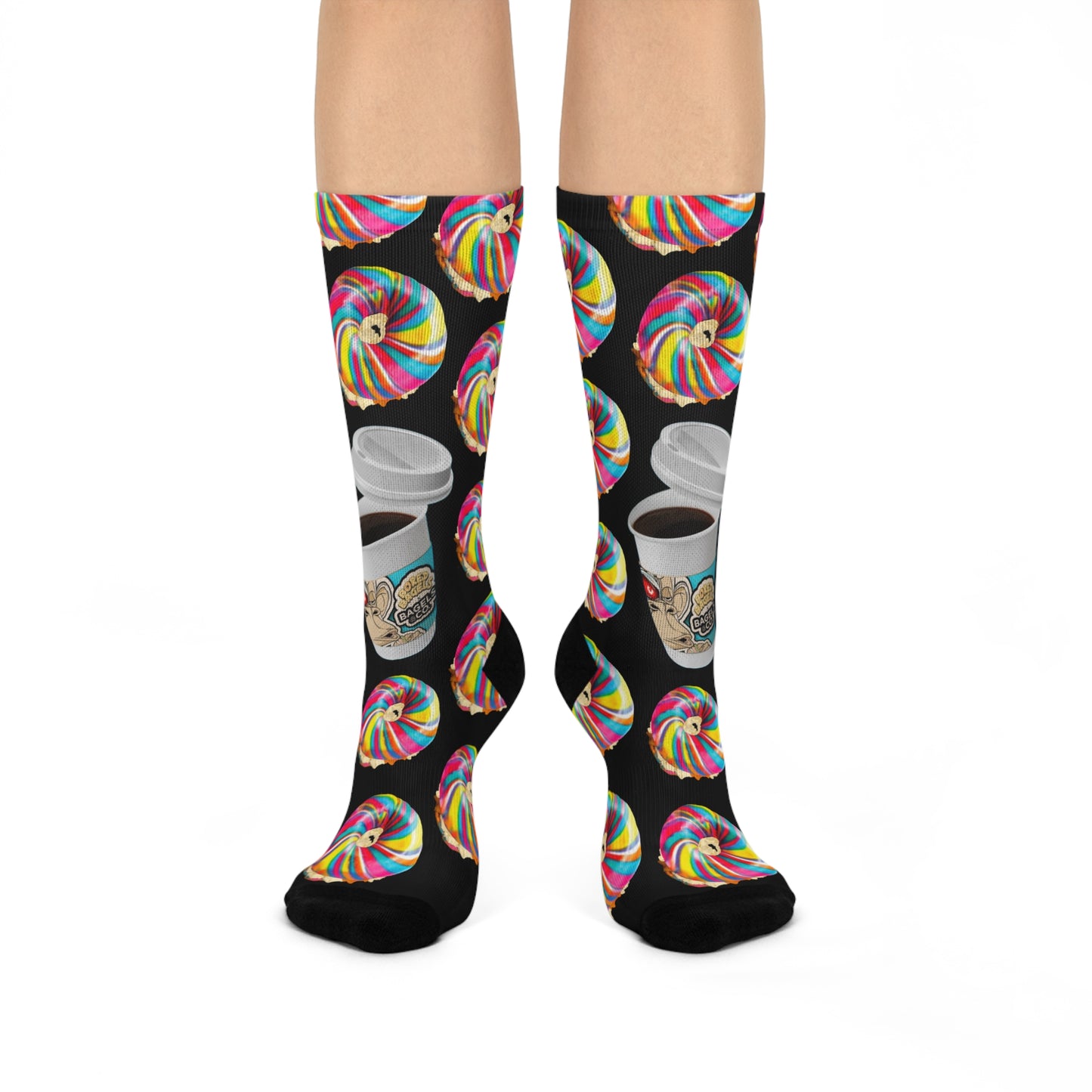 BORED SOCKS Collaboration showing crew socks with black background with allover pattern of colorful rainbow striped bagel (teal, yellow and rose) with cream cheese and lox with a large cup of takeout coffee displaying the Bored Bagels brand.